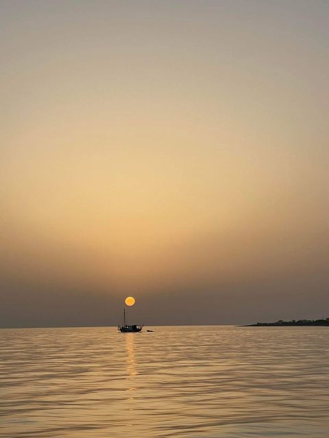 Argostoli: Sunset Cruise with Swim Stops, Dinner, and Wine - Xi Beach and its red-brick-colored sand