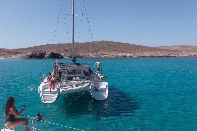 Catamaran Day & Sunset Cruises with meals Drinks and transportation - Leaving Tourlos with Mykonos behind you