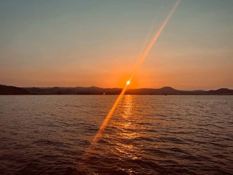 Faliraki: Sunset Cruise with Unlimited Aperol, Beers & Wine - Sailing toward Anthony Quinn Bay