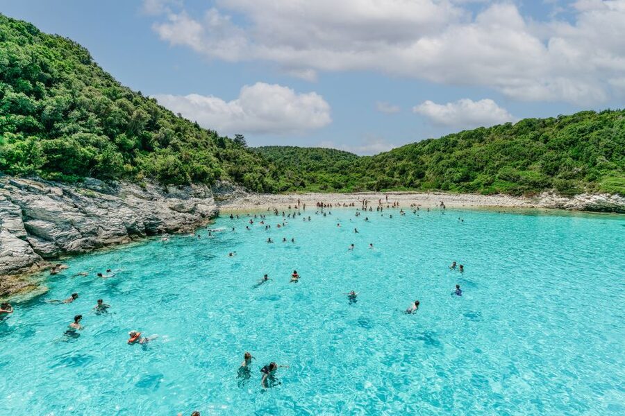 From Corfu Island: Antipaxos & Paxos Blue Caves Boat Cruise - Food, drinks, and the lively return to Corfu