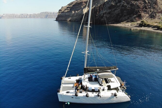Half-Day Exclusive Catamaran Cruise in Santorini with Meal and Open Bar - Red Beach and the southern volcanic coast