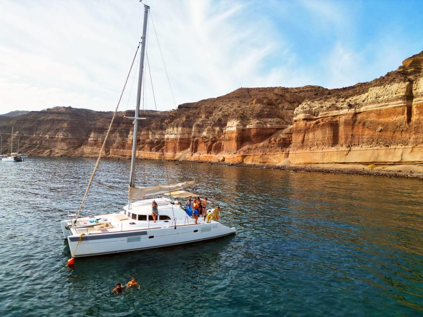 Santorini: Catamaran Cruise with Greek BBQ and Drinks - Red Beach: Santorini’s most unusual shoreline