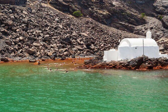 Santorini Classic Catamaran Cruise with BBQ, Drinks and Transfers - The lighthouse and the caldera edge