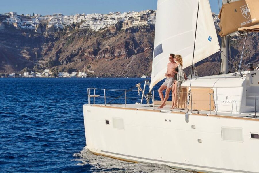 Santorini Gold Catamaran Cruise with Snorkel, BBQ & Open Bar - White Beach, the lighthouse, and cliff-side villages