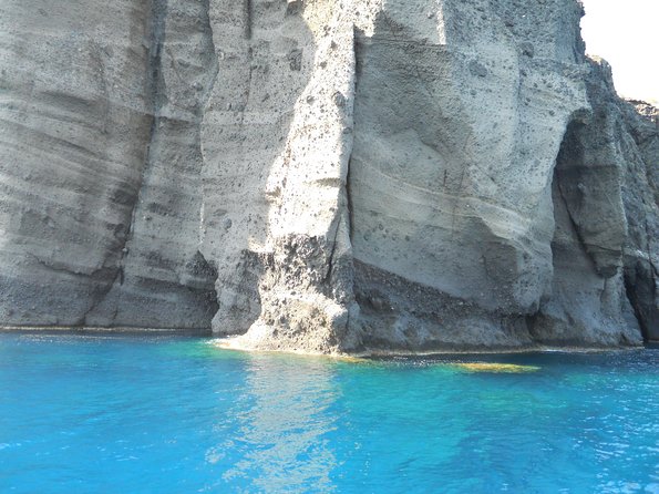 Santorini Luxury Catamaran Sunset Cruise with BBQ, Drink and Transfer - Red Beach from the water