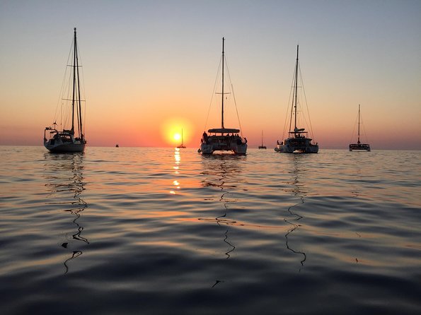 Santorini Luxury Catamaran Sunset Cruise with BBQ, Drink and Transfer - The sunset is the main event