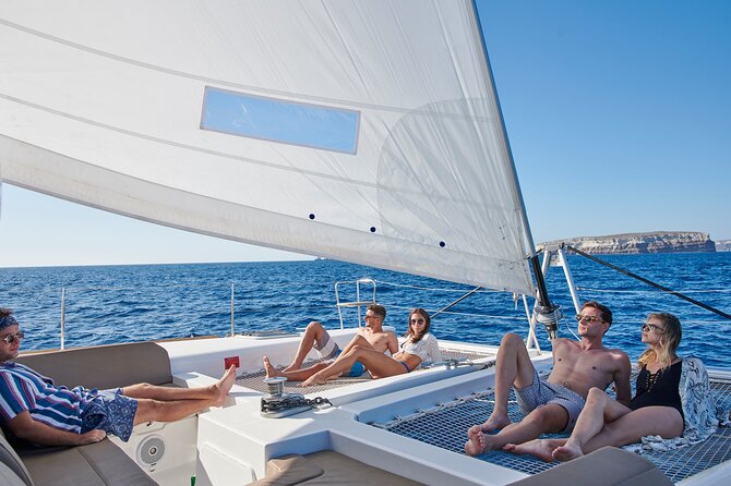 Santorini Platinum Catamaran Cruise with Meal, BBQ and Open Bar - The Akrotiri lighthouse adds a striking photo stop
