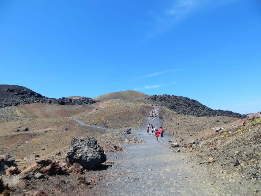 Santorini Port: 3 Hour Cruise to Volcano and Hot Springs - Walking across Nea Kameni’s black volcanic ground