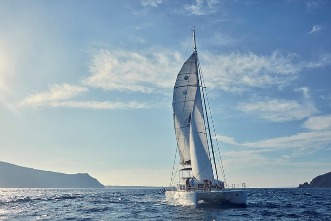 Santorini Sunset Luxury Sailing Catamaran Cruise with BBQ, drinks, transfer - The lighthouse, caldera, and volcanic hot springs