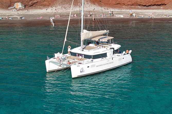 Santorini Sunset Sailing Cruise: Dinner, BBQ, Open Bar, Transfers - From Vlychada Port to Red Beach